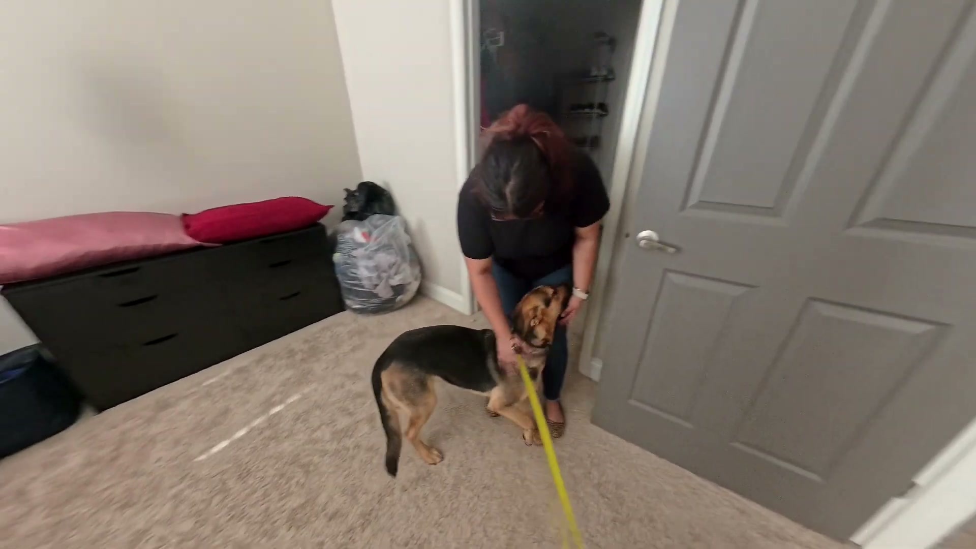 Stormi’s owner bends down beside her during the lesson at home; the long line remains visible.
